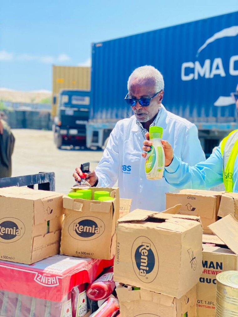 Dr Ali Mohamed Sheikh inspecting imported goods at Mogadishu Port quality control Somalia